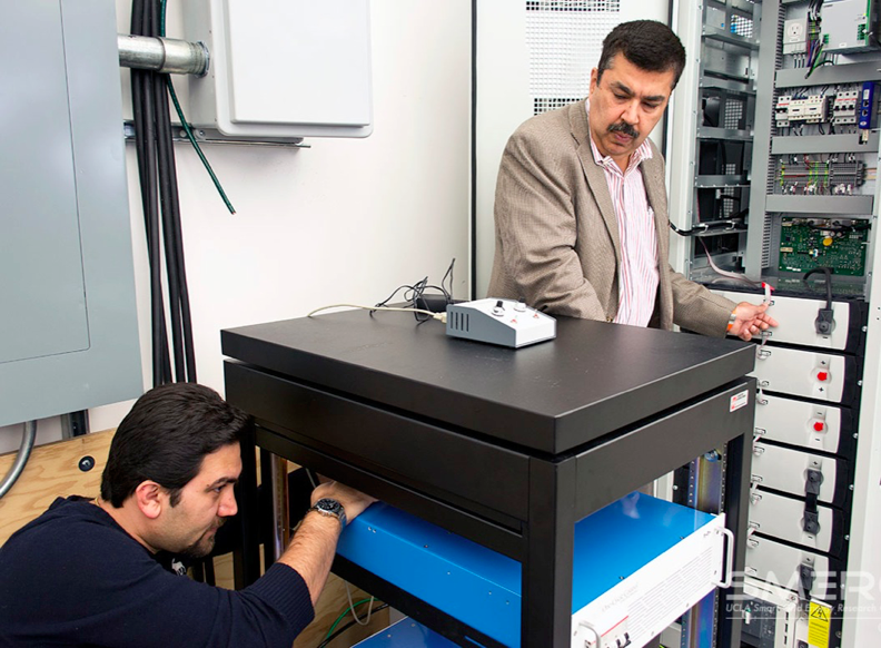 Researchers at the Smart Grid Energy Research Center at UCLA, including Professor Rajit Gadh (right), develop technologies to reduce energy use in common devices and return power to the grid for distribution to others.